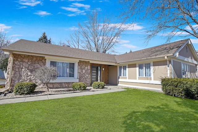 ranch-style home with stone siding, a shingled roof, and a front yard