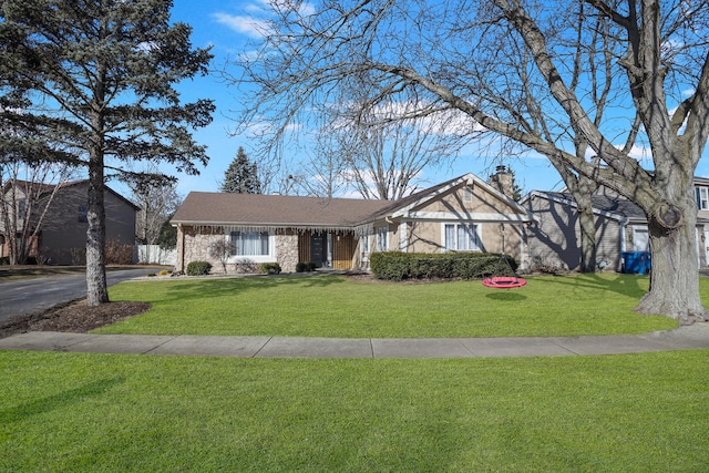 view of front of house with driveway, a front lawn, and a chimney