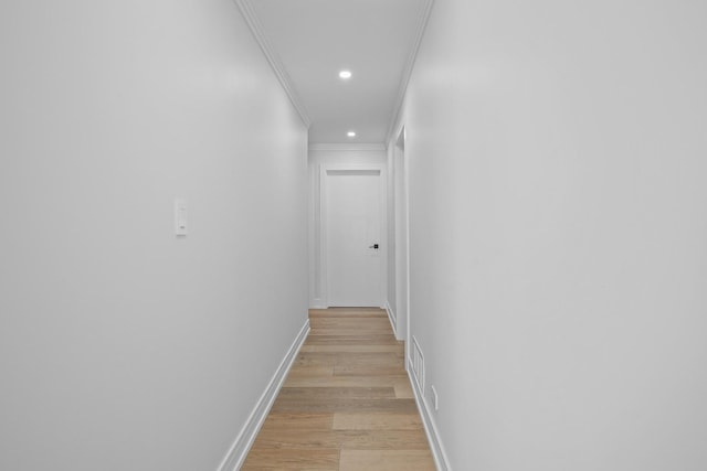 hall featuring recessed lighting, visible vents, ornamental molding, light wood-type flooring, and baseboards