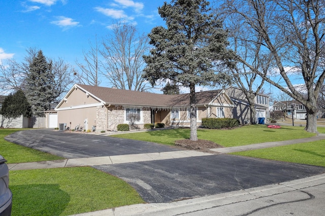 view of front of house with aphalt driveway, a garage, stone siding, stucco siding, and a front lawn