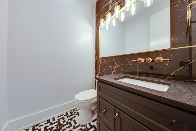 bathroom with tasteful backsplash, toilet, and vanity