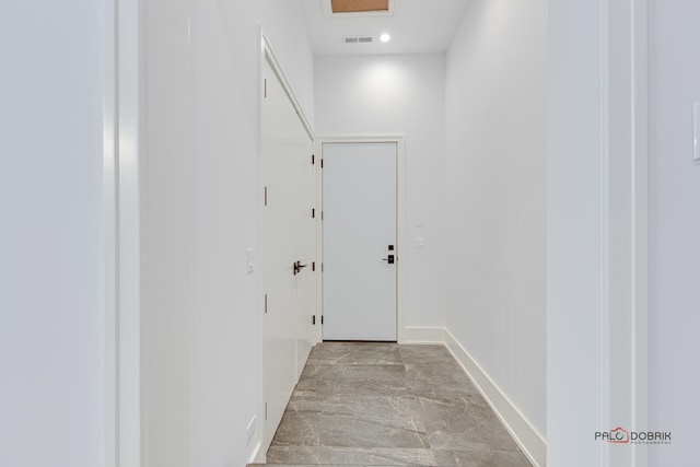 hall with recessed lighting, visible vents, baseboards, and marble finish floor