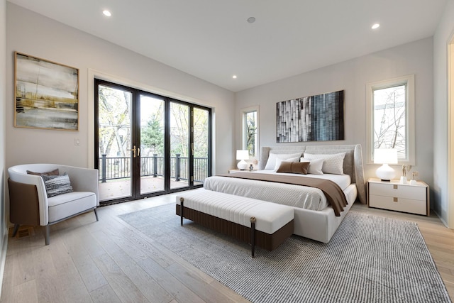 bedroom with access to outside, multiple windows, and recessed lighting