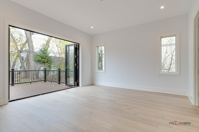 spare room with recessed lighting, baseboards, and light wood-style floors