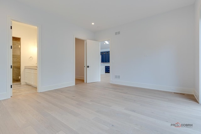 unfurnished bedroom with visible vents, baseboards, and light wood-style floors