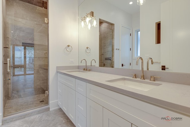 bathroom with double vanity, a stall shower, and a sink