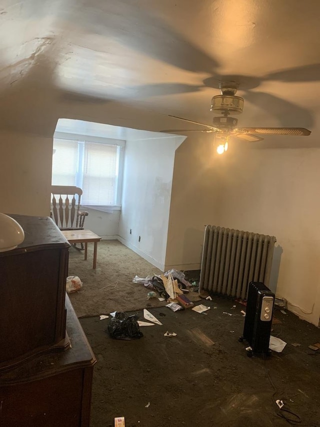 bonus room featuring ceiling fan and radiator heating unit