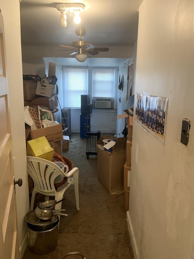 interior space with carpet floors, cooling unit, and ceiling fan