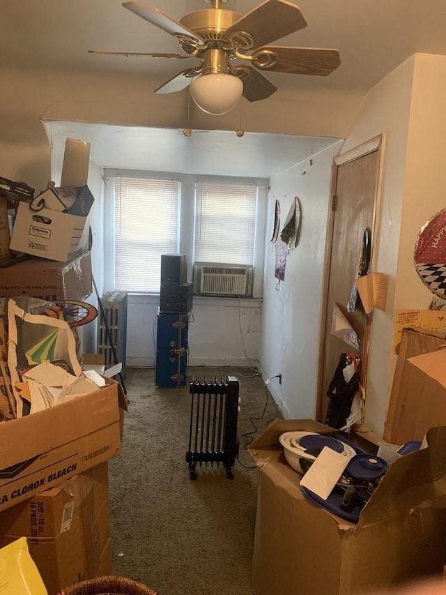 interior space with ceiling fan, carpet floors, and cooling unit