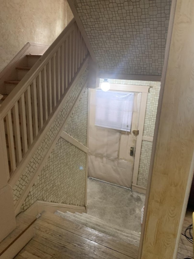 bonus room with hardwood / wood-style floors and stairway