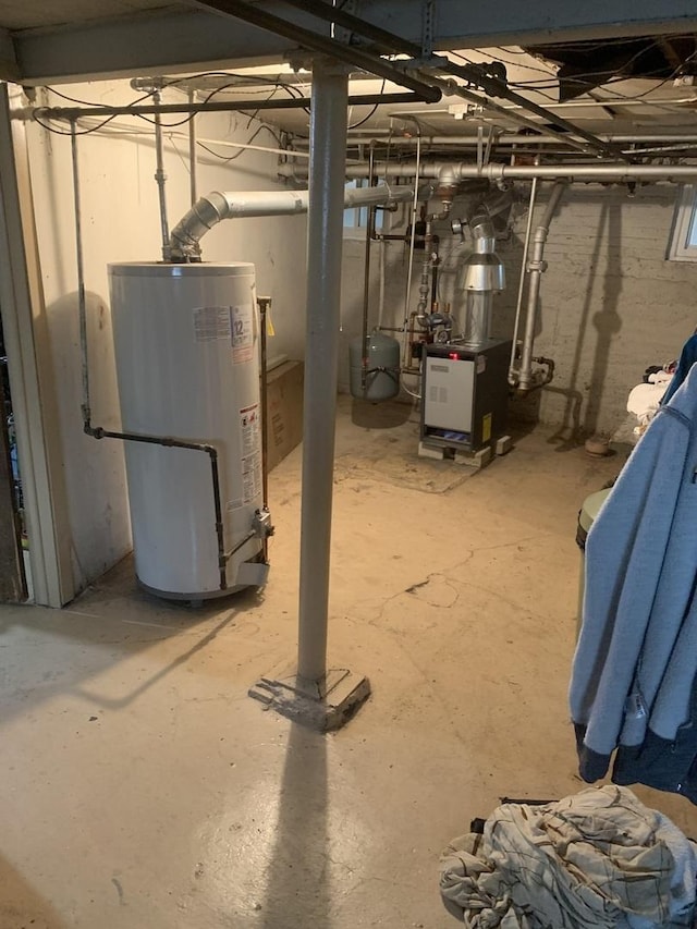 unfinished below grade area featuring water heater