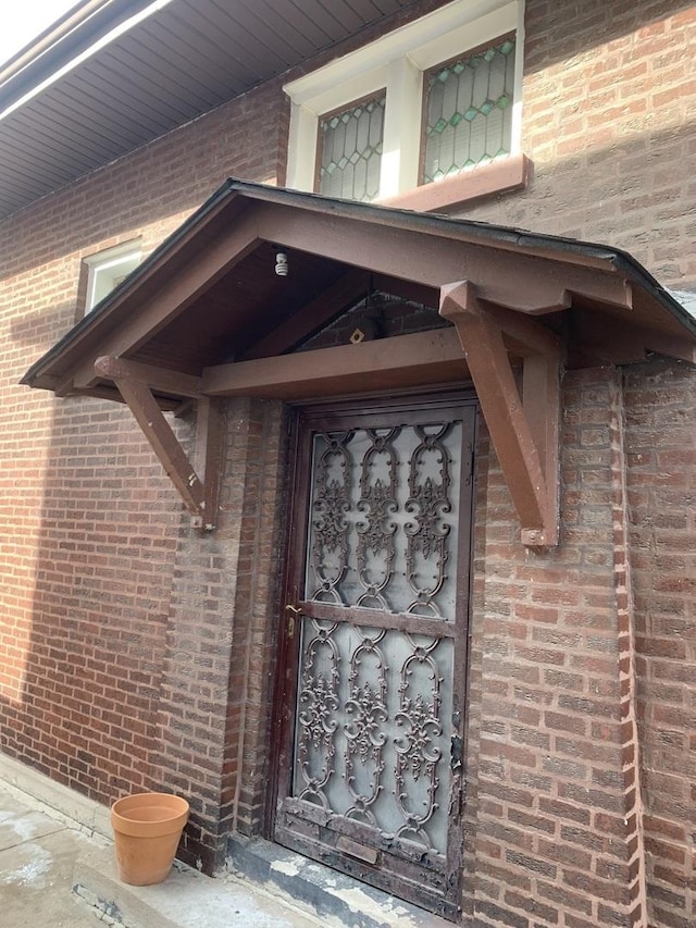 property entrance featuring brick siding