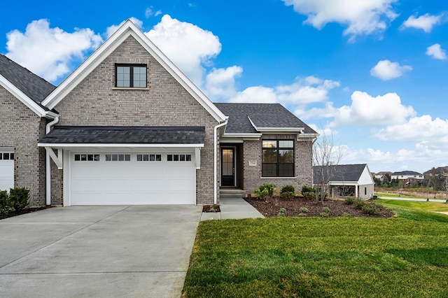 view of front of house featuring an attached garage, brick siding, concrete driveway, roof with shingles, and a front lawn