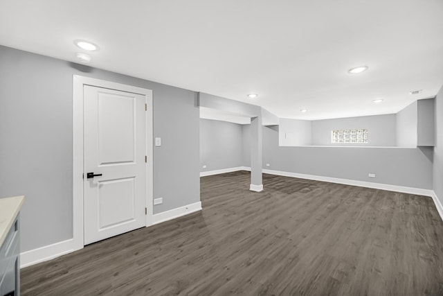 finished basement with baseboards, dark wood-type flooring, and recessed lighting