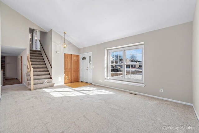 entrance foyer with visible vents, light carpet, stairway, and baseboards