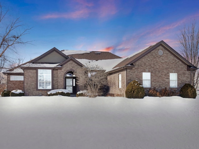 ranch-style house featuring brick siding