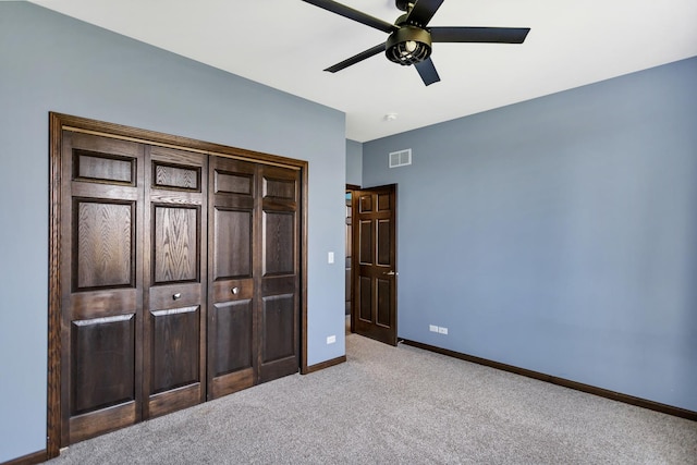 unfurnished bedroom featuring baseboards, visible vents, ceiling fan, and light colored carpet