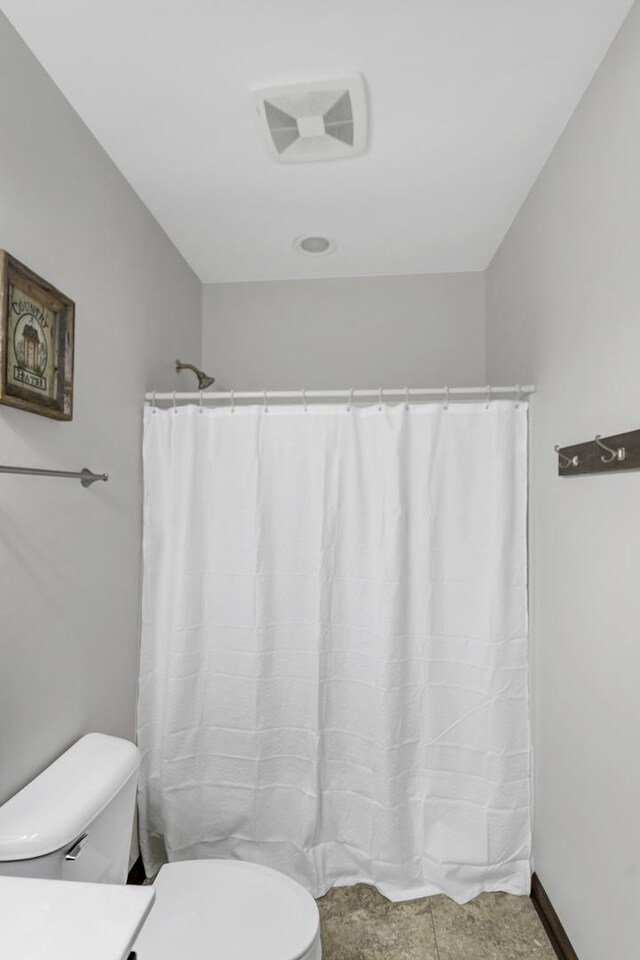 bathroom featuring visible vents and toilet