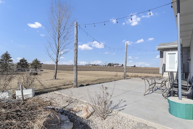 view of yard featuring a patio area and a rural view