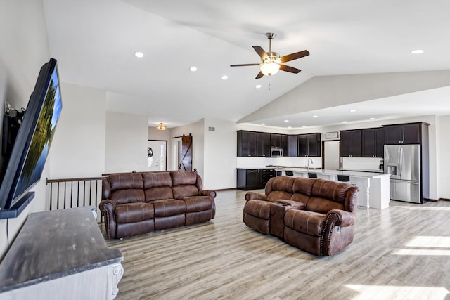 living room featuring baseboards, ceiling fan, light wood-type flooring, high vaulted ceiling, and recessed lighting