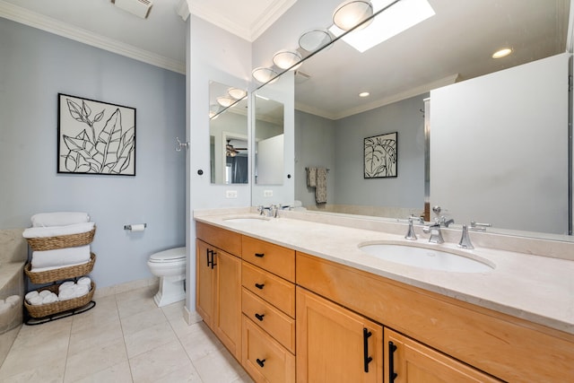 bathroom featuring toilet, a sink, visible vents, and crown molding