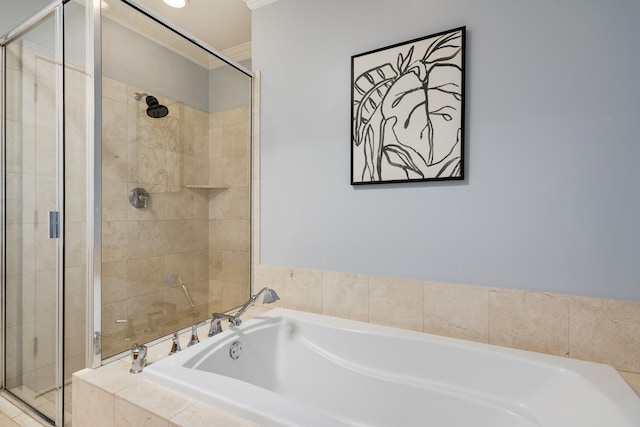 bathroom with a stall shower, a garden tub, and crown molding