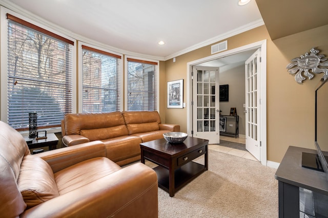 living area with french doors, crown molding, recessed lighting, visible vents, and light carpet