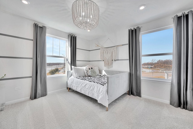 carpeted bedroom featuring a notable chandelier, recessed lighting, and baseboards