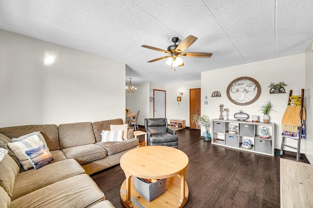 living area with dark wood-type flooring, a textured ceiling, and ceiling fan with notable chandelier