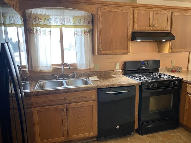 kitchen featuring range hood, brown cabinets, decorative backsplash, a sink, and black appliances