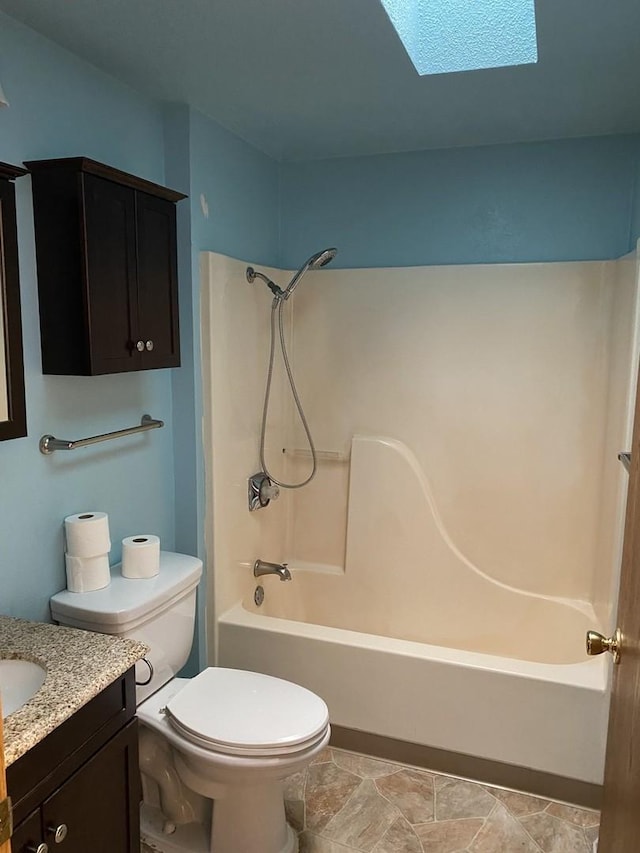 full bath featuring toilet, a skylight, shower / washtub combination, and vanity