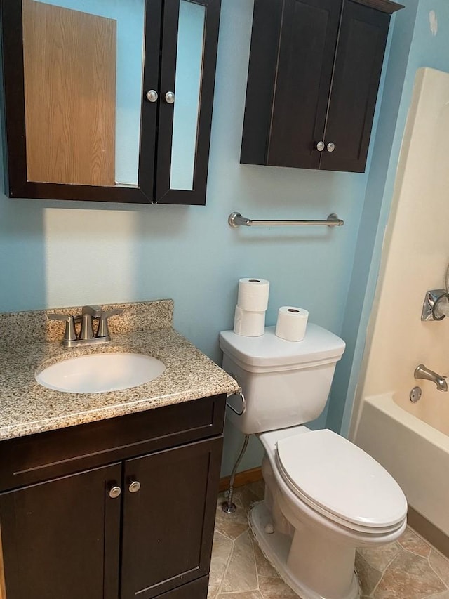 bathroom featuring  shower combination, vanity, and toilet