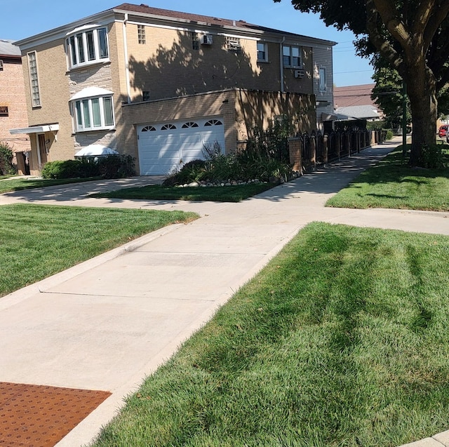 view of front facade featuring driveway, brick siding, and a front lawn