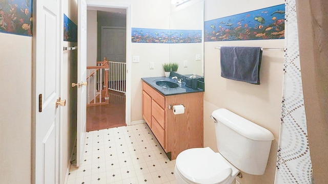 full bathroom featuring toilet, vanity, and tile patterned floors