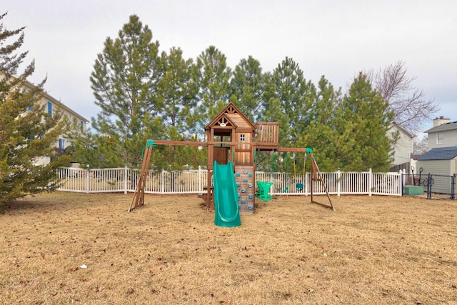 view of playground with fence and a lawn