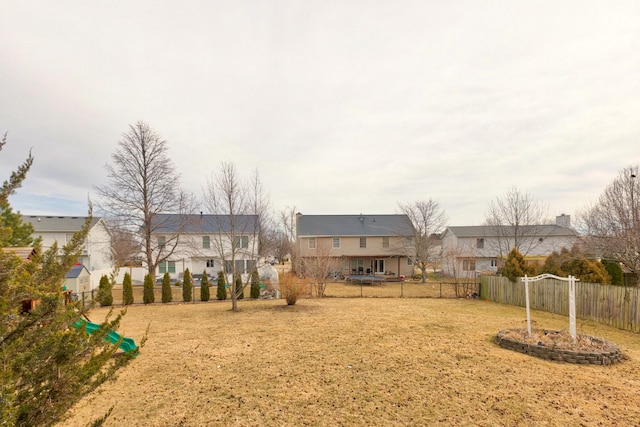 view of yard featuring a fenced backyard and a residential view