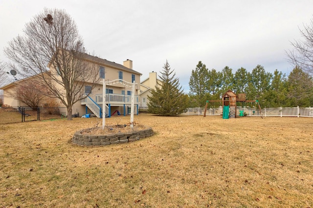 view of yard featuring a fenced backyard and playground community