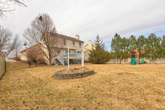 view of yard with a fenced backyard and a playground