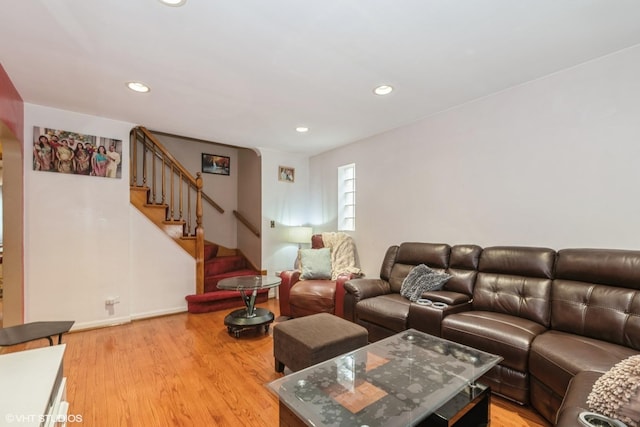 living area featuring light wood-style floors, stairs, baseboards, and recessed lighting