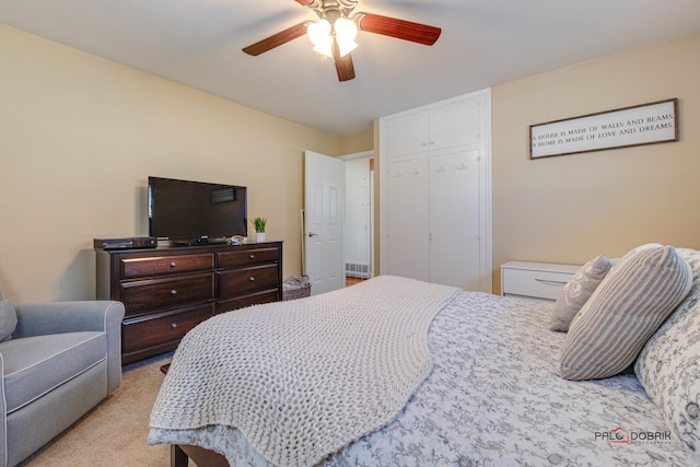 bedroom featuring ceiling fan, a closet, and light colored carpet