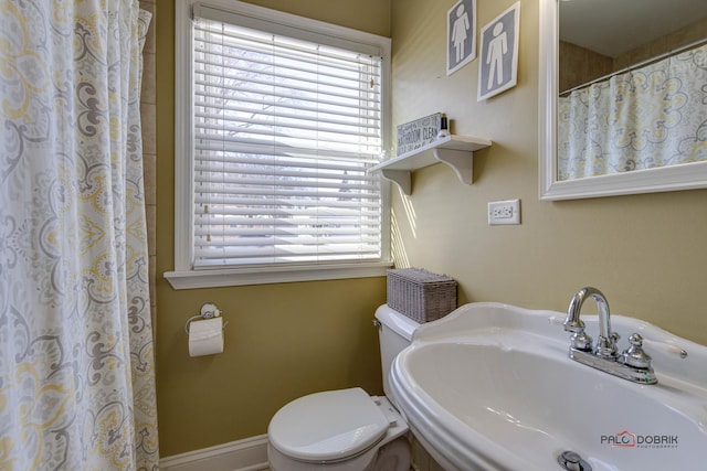 full bath featuring a healthy amount of sunlight, a sink, and toilet