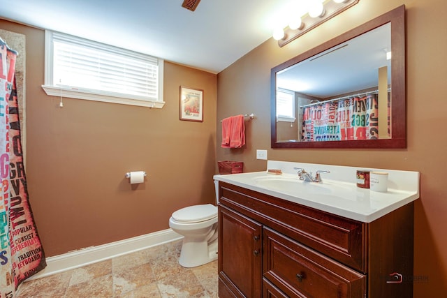 full bathroom featuring toilet, vanity, and baseboards