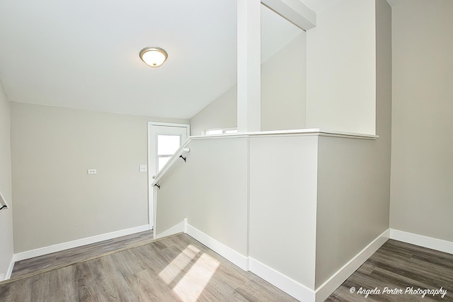 interior space featuring baseboards and wood finished floors