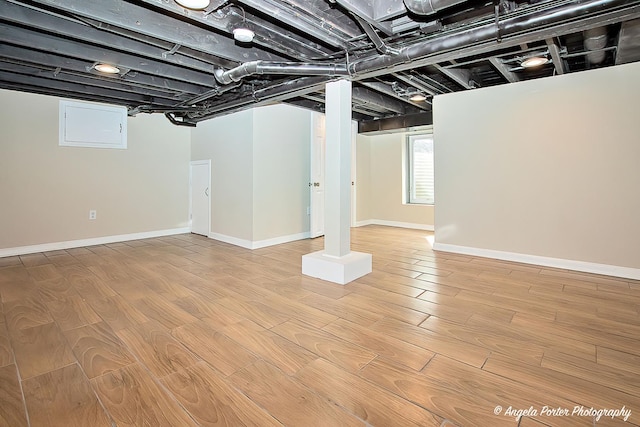 below grade area with baseboards and wood finished floors