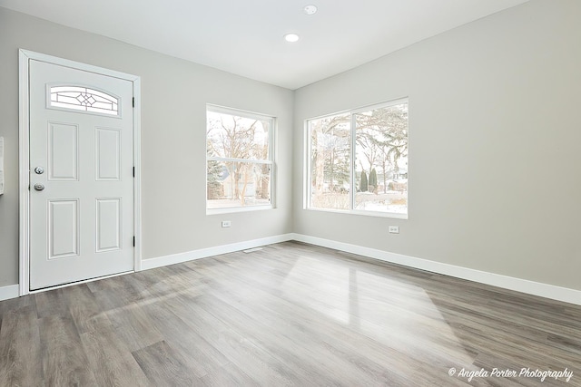 entryway featuring recessed lighting, wood finished floors, and baseboards