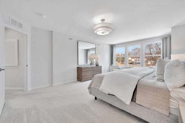 carpeted bedroom with baseboards and visible vents