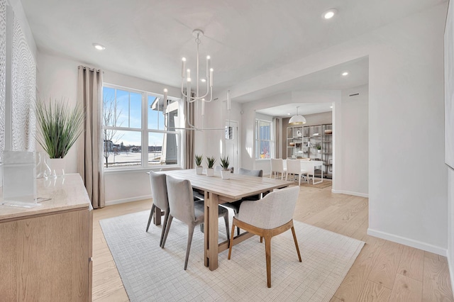 dining room with baseboards, a notable chandelier, light wood-style floors, and recessed lighting