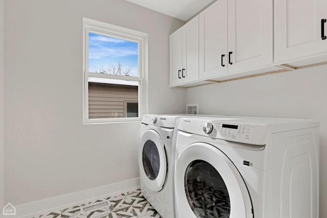 laundry area with light floors, washing machine and dryer, cabinet space, and baseboards