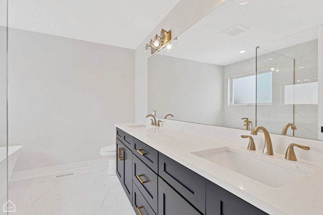 full bath featuring toilet, marble finish floor, baseboards, and a sink