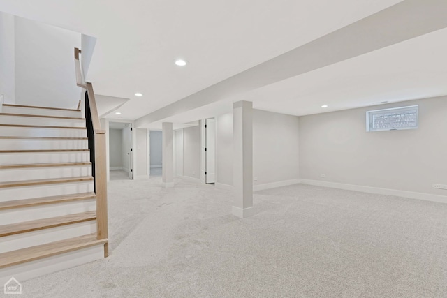 below grade area with recessed lighting, light carpet, baseboards, and stairs